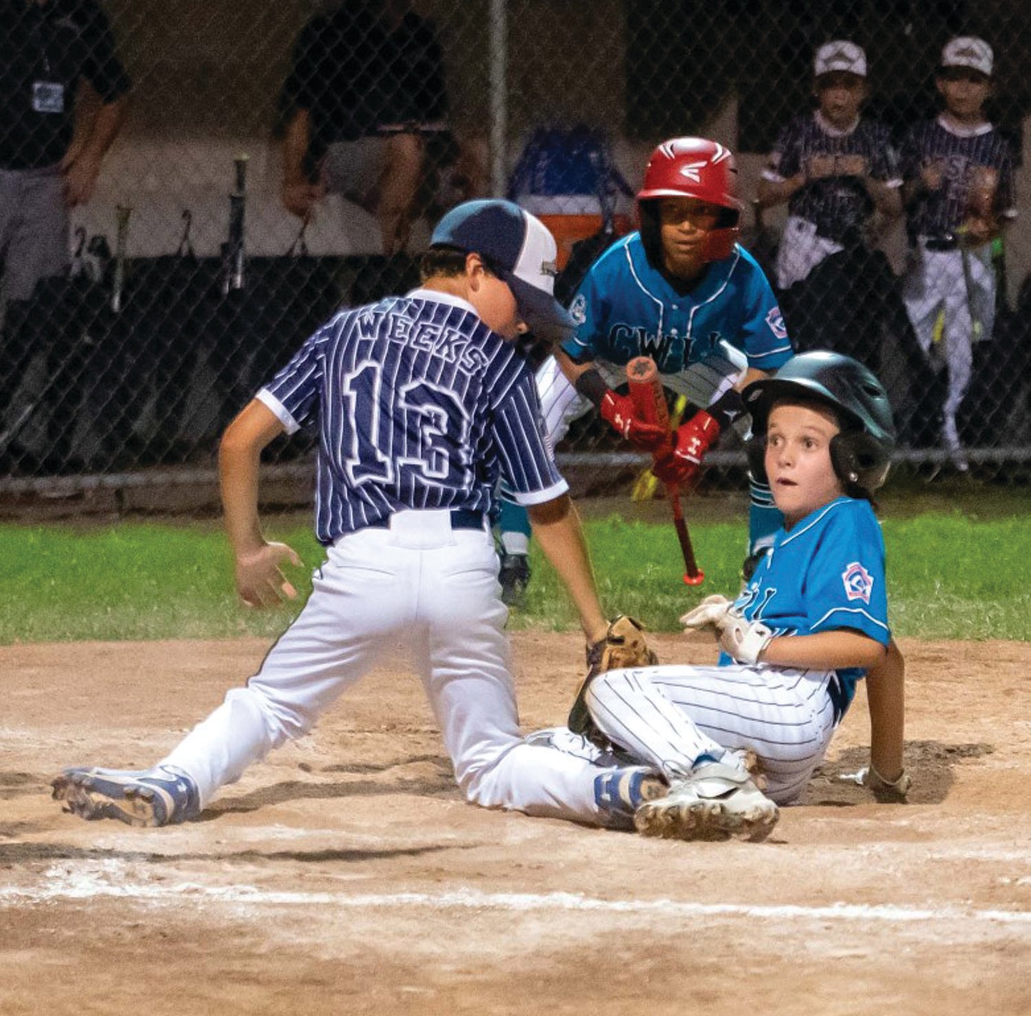 THE PLAY AT THE PLATE: CWLL’s Tommy Glasgow slides into home plate.